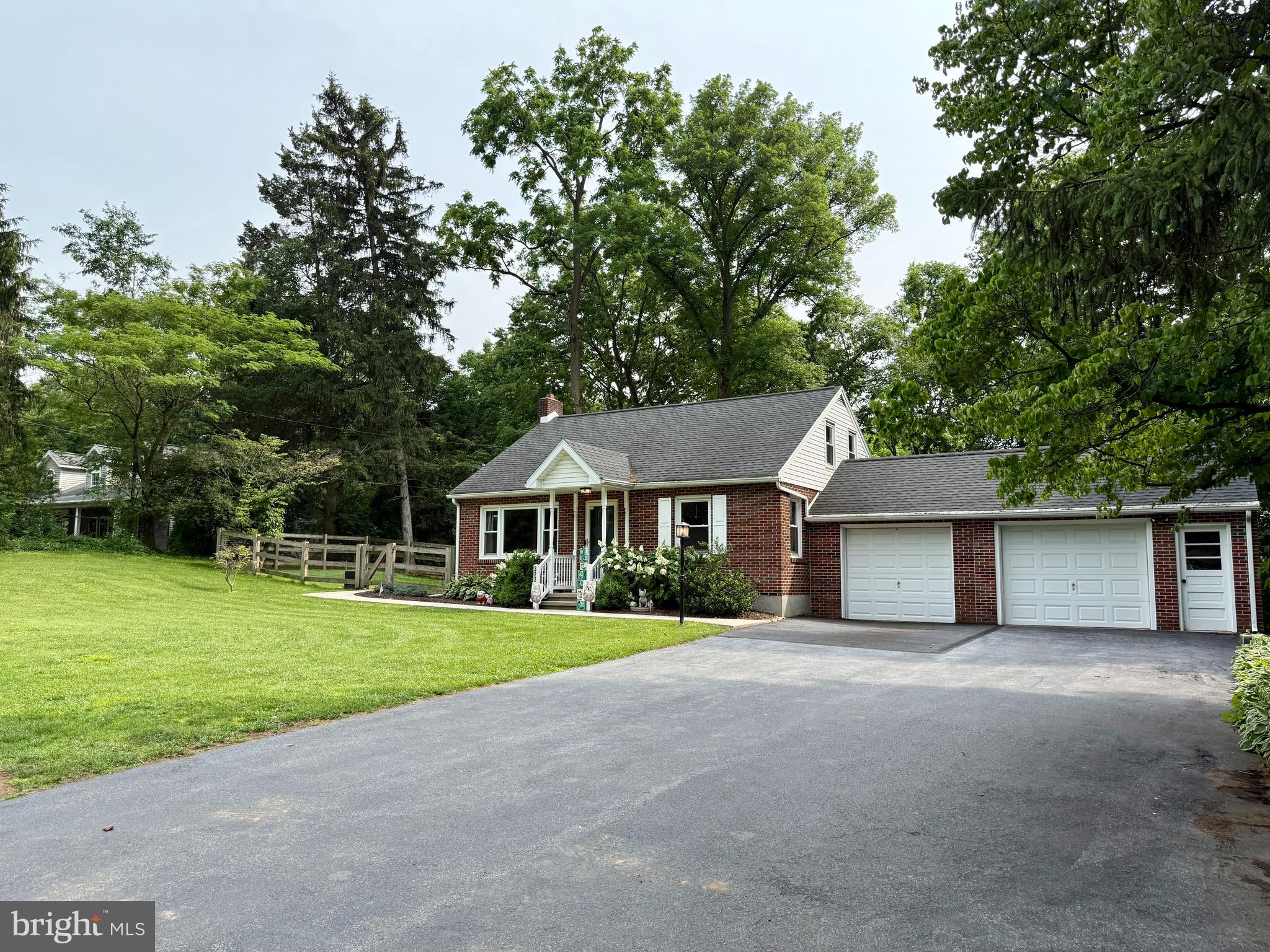 3226 State Hill Road Reading, PA 19608 - Photo 46 of 54 a front view of a house with a garden and trees