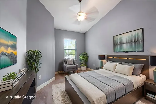 a bedroom with a large bed and a potted plant