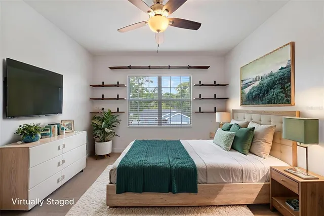 a bedroom with a bed and a flat screen tv