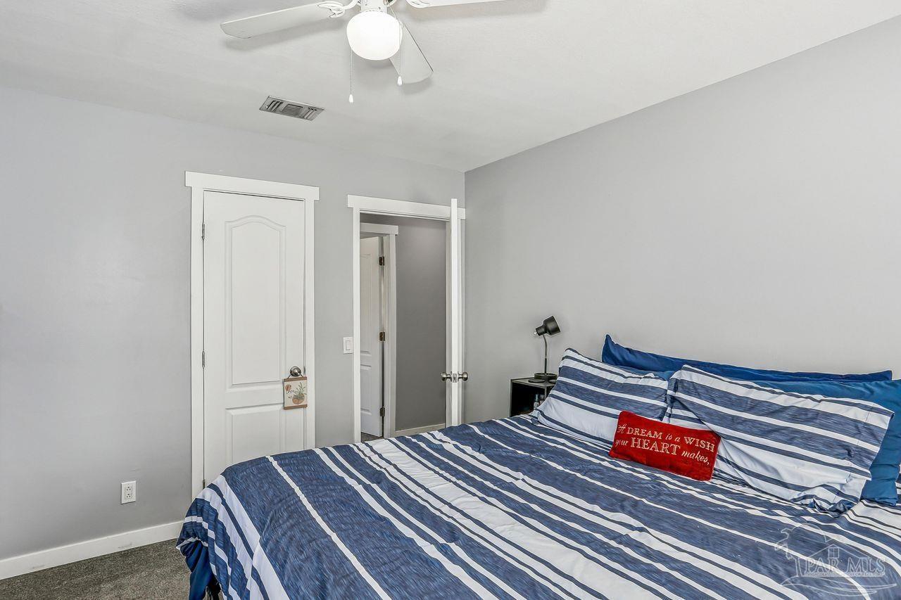 4010 Wyndham Road Century, FL 32535 - Photo 14 of 25 a bedroom with a bed and a chandelier
