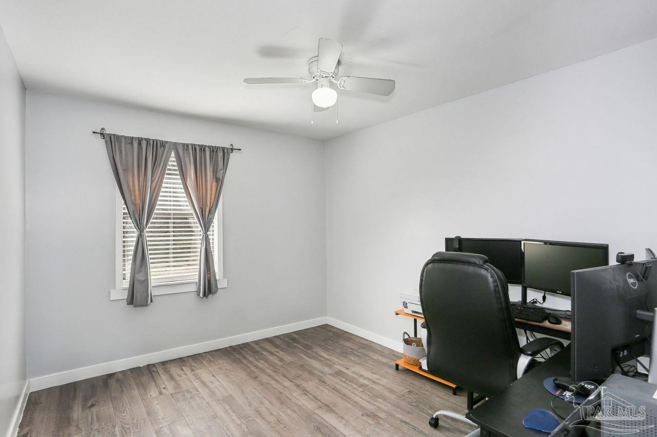 4010 Wyndham Road Century, FL 32535 - Photo 16 of 25 a view of workspace with wooden floor windows