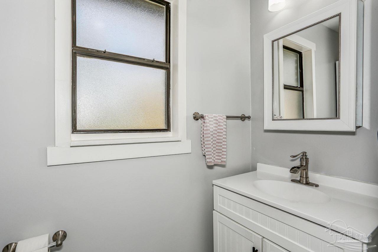 4010 Wyndham Road Century, FL 32535 - Photo 18 of 25 a bathroom with a sink and mirror with window