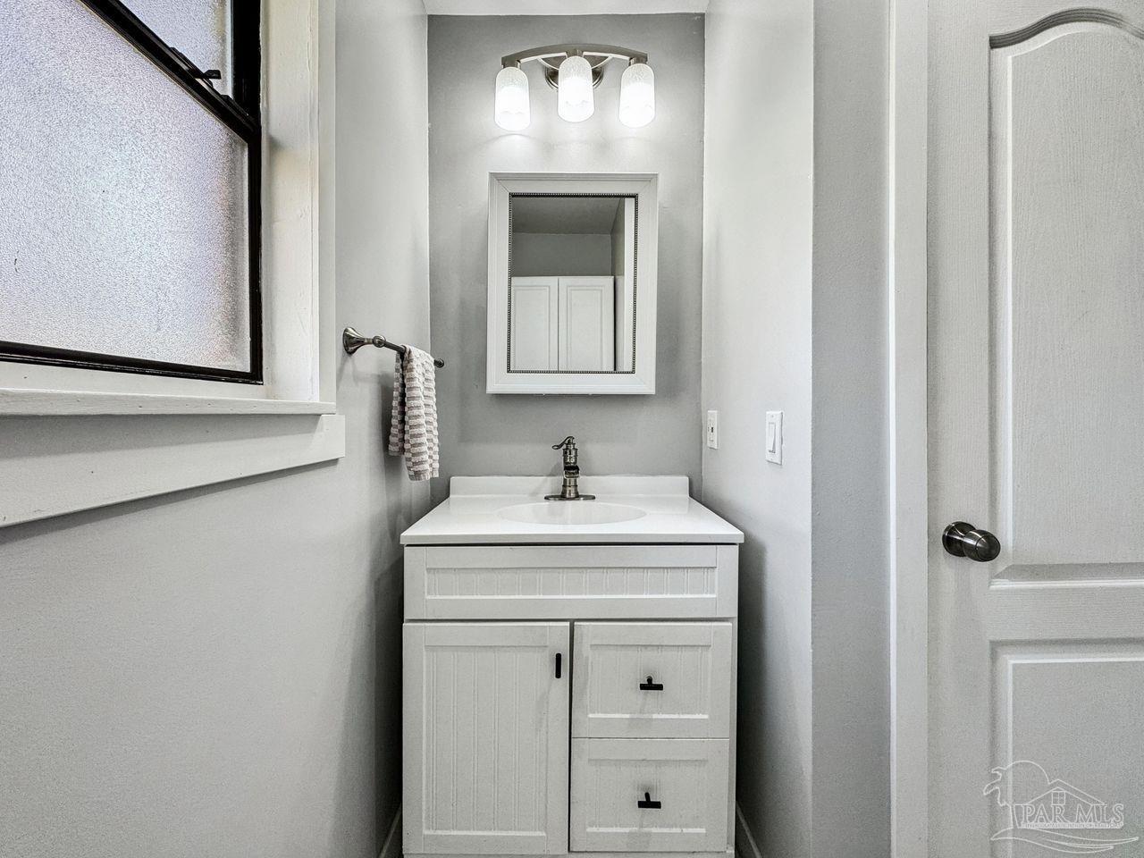 4010 Wyndham Road Century, FL 32535 - Photo 19 of 25 a bathroom with a sink and a mirror