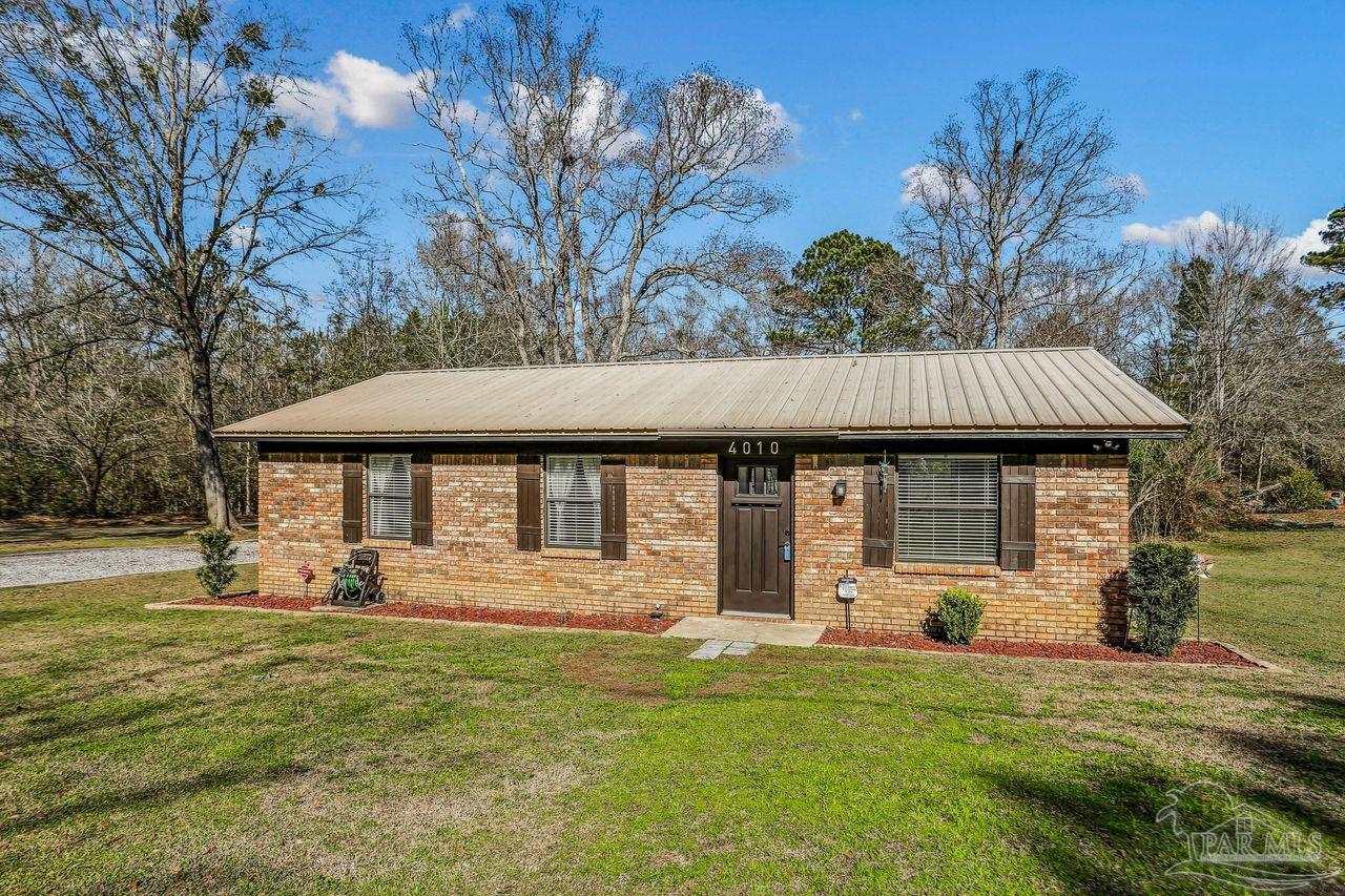 4010 Wyndham Road Century, FL 32535 - Photo 3 of 25 a front view of a house with garden