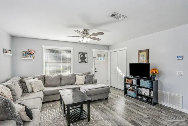a living room with furniture and a flat screen tv