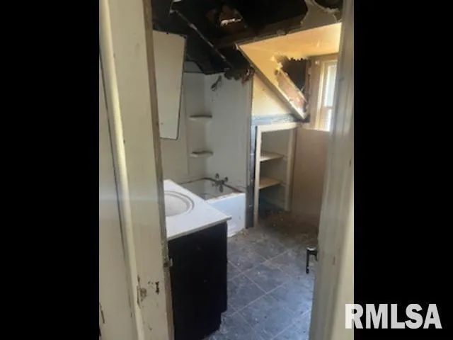 a bathroom with a sink and mirror