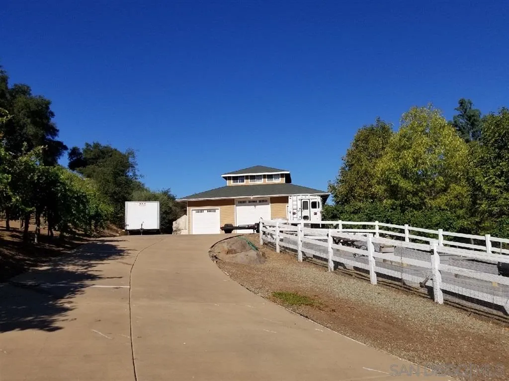 18259 Chablis Road Ramona, CA 92065 - Photo 19 of 24 a view of a patio with table and chairs with wooden fence