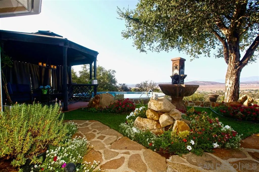 18259 Chablis Road Ramona, CA 92065 - Photo 3 of 24 a front view of a house with garden