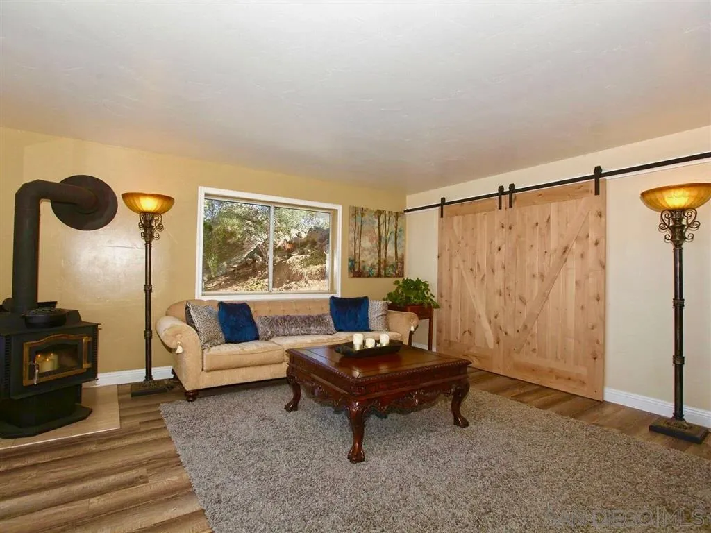 18259 Chablis Road Ramona, CA 92065 - Photo 5 of 24 a living room with furniture and a floor to ceiling window