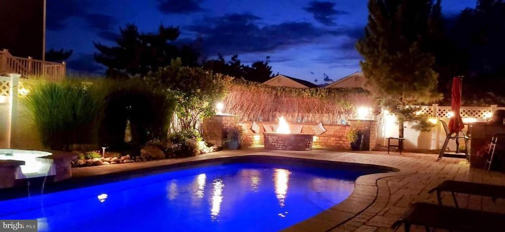 108 West 10th Street Ship Bottom, NJ 08008 - Photo 3 of 47 Serene evening by the illuminated pool.