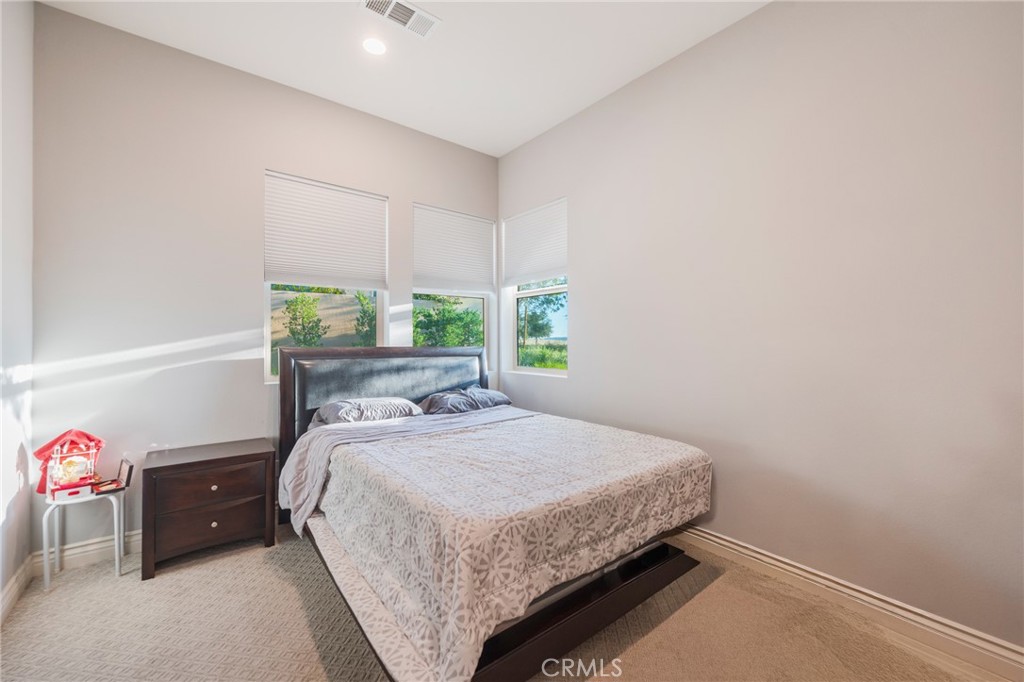 102 Spectacle Irvine, CA 92618 - Photo 19 of 40 a bedroom with a bed and a window