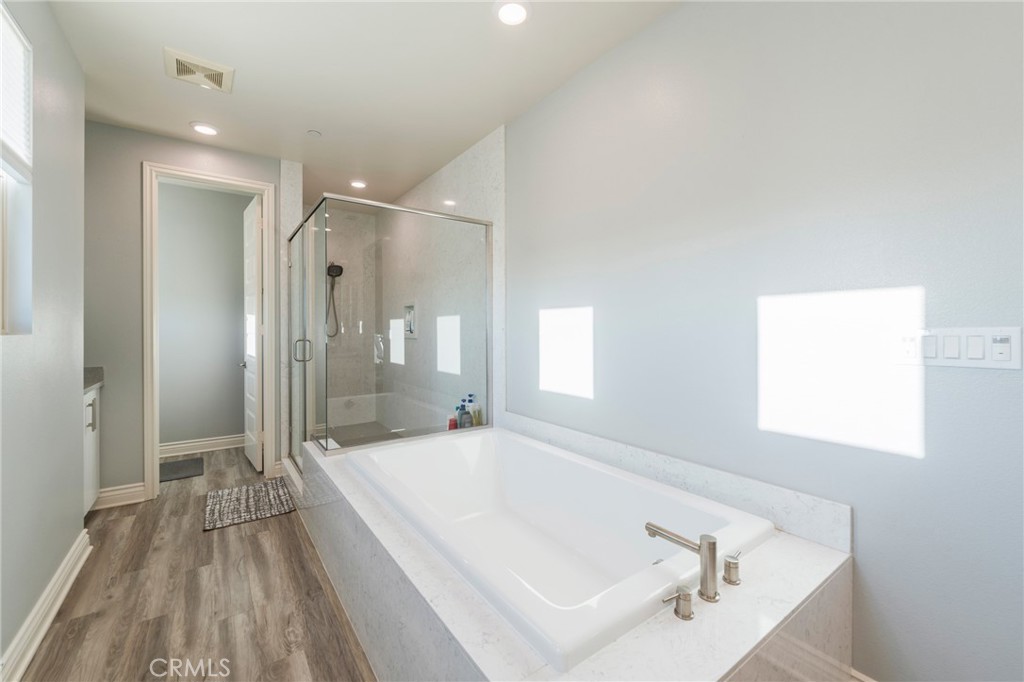102 Spectacle Irvine, CA 92618 - Photo 23 of 40 a spacious bathroom with a tub shower and sink