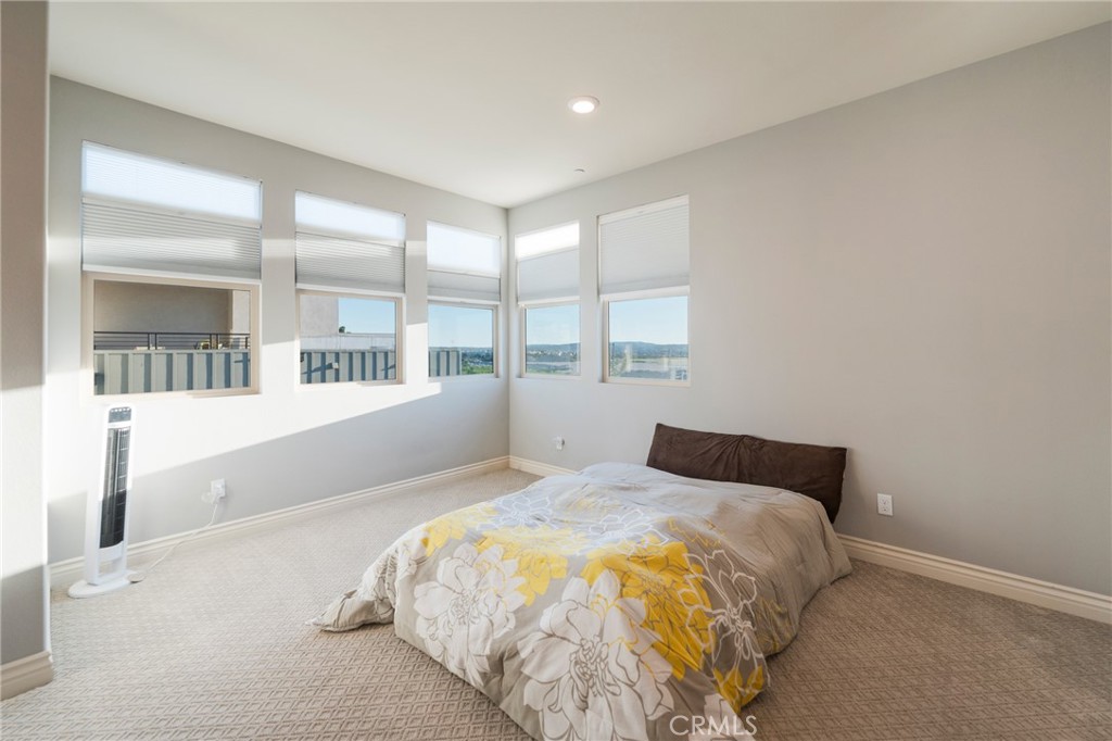 102 Spectacle Irvine, CA 92618 - Photo 31 of 40 a bedroom with a bed and a large window