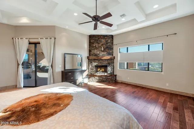 a bedroom with a bed a desk and chair with the bookshelf