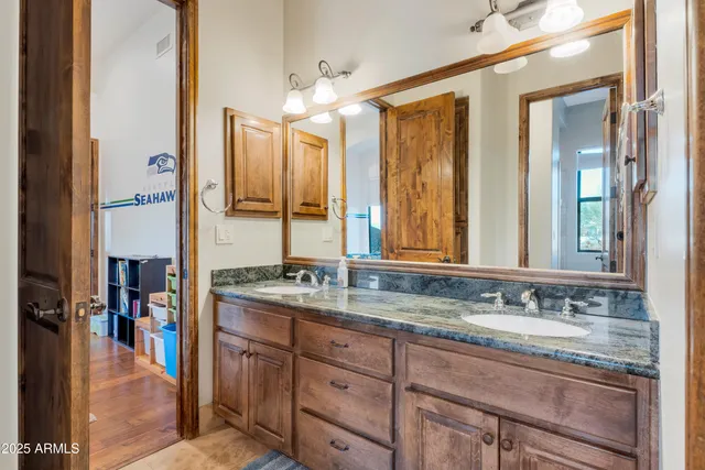 a view of a living room with a floor to ceiling window and an outdoor kitchen
