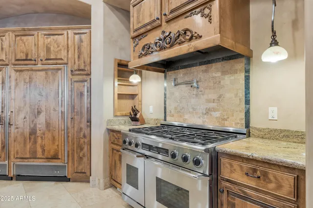 a kitchen with stainless steel appliances granite countertop a sink and stove