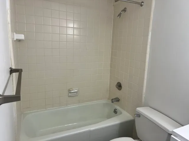 a bathroom with a bathtub and toilet