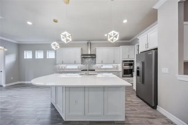 a large kitchen with kitchen island a sink stainless steel appliances and cabinets