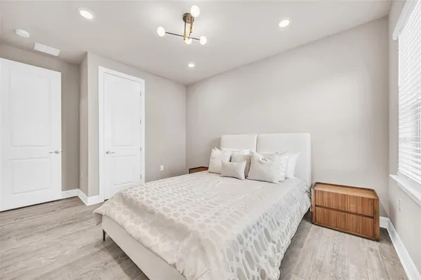 a bedroom with a bed and window