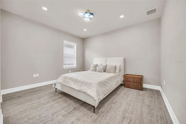 a bedroom with a large bed and a window