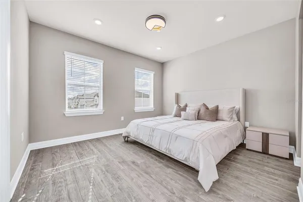 a large bedroom with a bed and a window