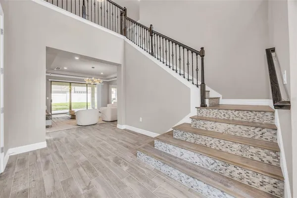 a view of entryway and hall with wooden floor