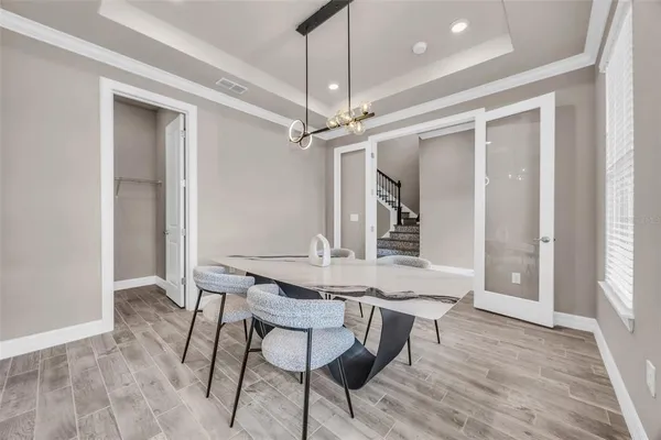 a view of a dining room with furniture window and wooden floor