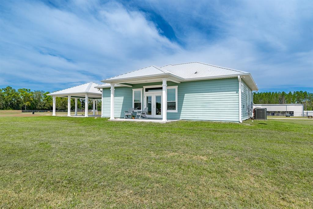 6095 Southwest 82nd Place Trenton, FL 32693 - Photo 14 of 44 a front view of a house with a garden