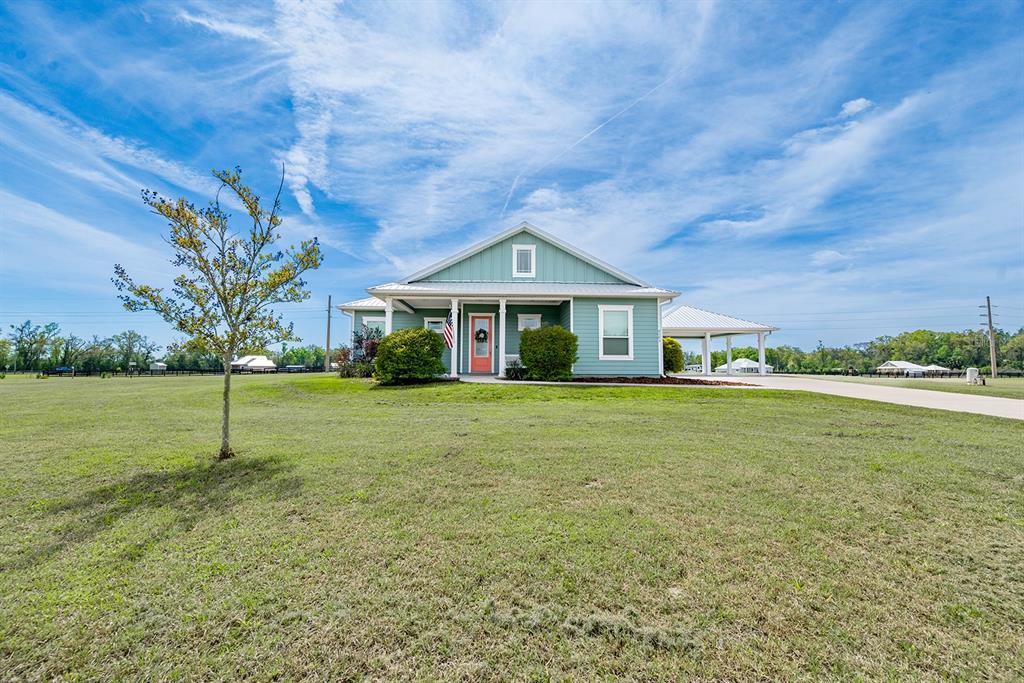 6095 Southwest 82nd Place Trenton, FL 32693 - Photo 2 of 44 a front view of a house with a yard