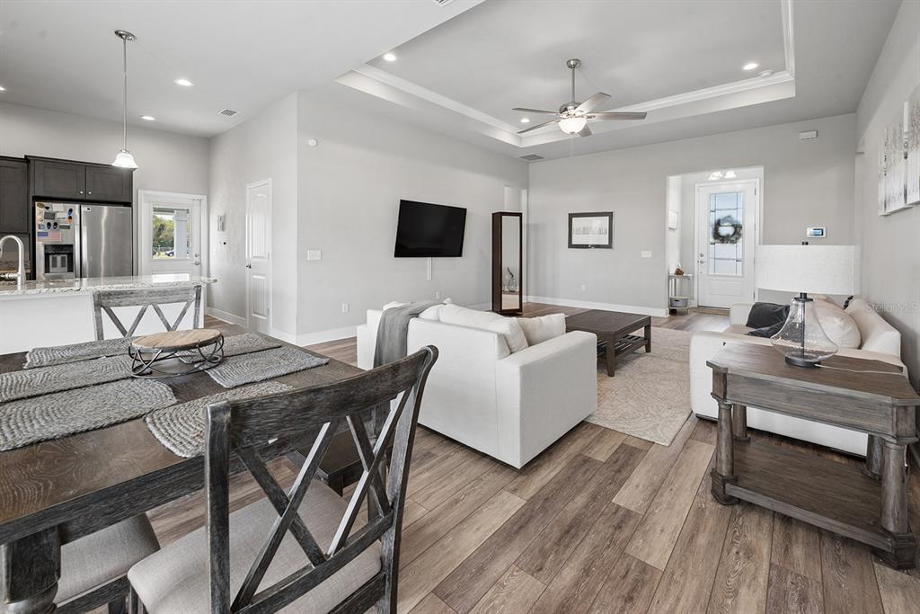 6095 Southwest 82nd Place Trenton, FL 32693 - Photo 22 of 44 a living room with furniture a flat screen tv and kitchen view