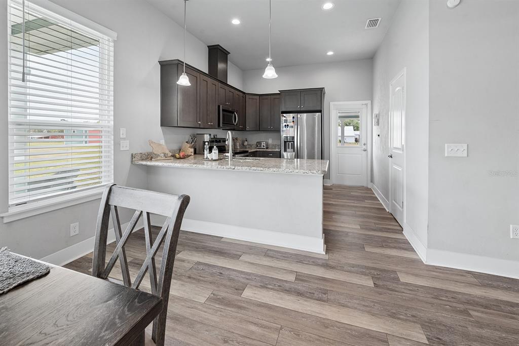 6095 Southwest 82nd Place Trenton, FL 32693 - Photo 26 of 44 a view of a dining room with furniture and wooden floor
