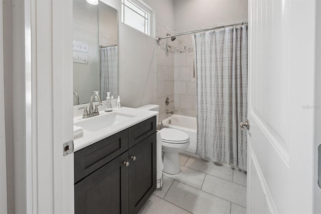 6095 Southwest 82nd Place Trenton, FL 32693 - Photo 29 of 44 a bathroom with a sink a toilet a mirror and shower