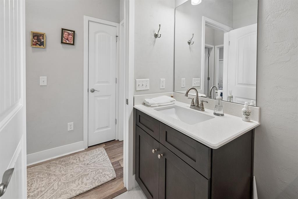 6095 Southwest 82nd Place Trenton, FL 32693 - Photo 30 of 44 a bathroom with a sink a mirror and a vanity