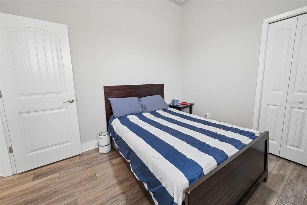 6095 Southwest 82nd Place Trenton, FL 32693 - Photo 32 of 44 a bedroom with a bed and wooden floor