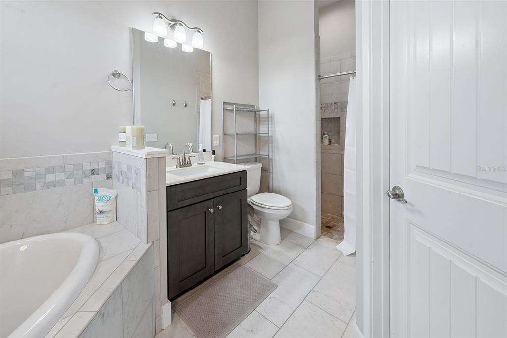 6095 Southwest 82nd Place Trenton, FL 32693 - Photo 38 of 44 a spacious bathroom with a bathtub sink mirror vanity and toilet
