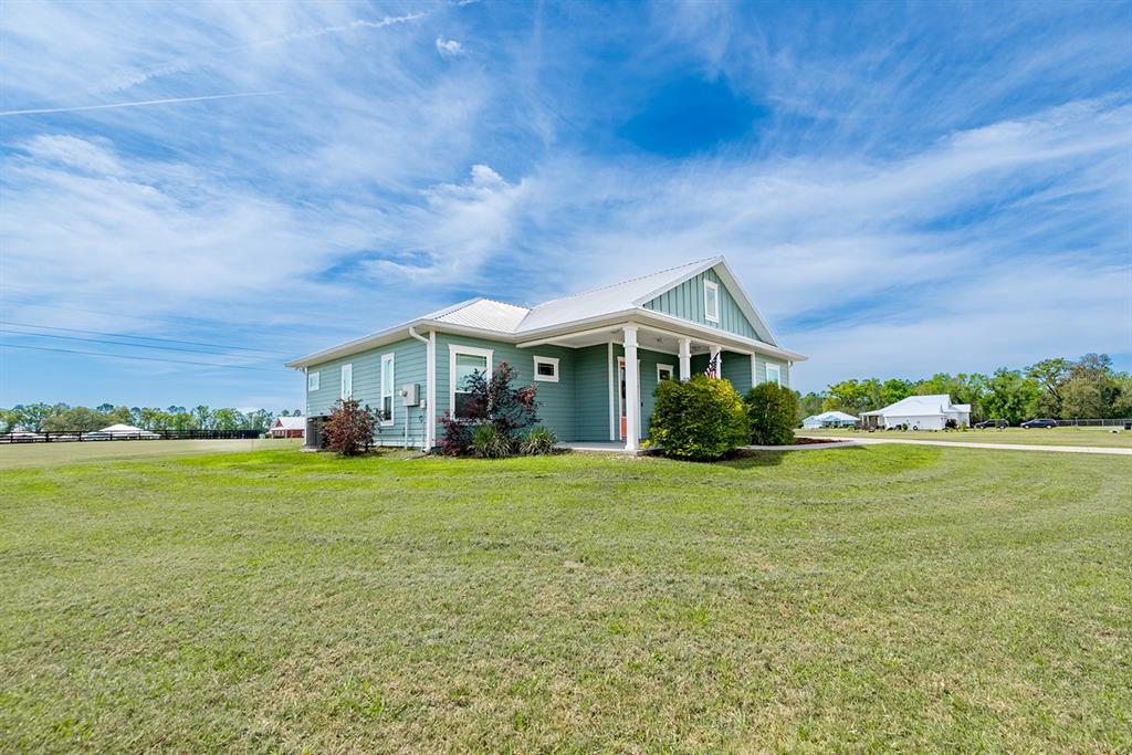 6095 Southwest 82nd Place Trenton, FL 32693 - Photo 4 of 44 a front view of a house with a yard