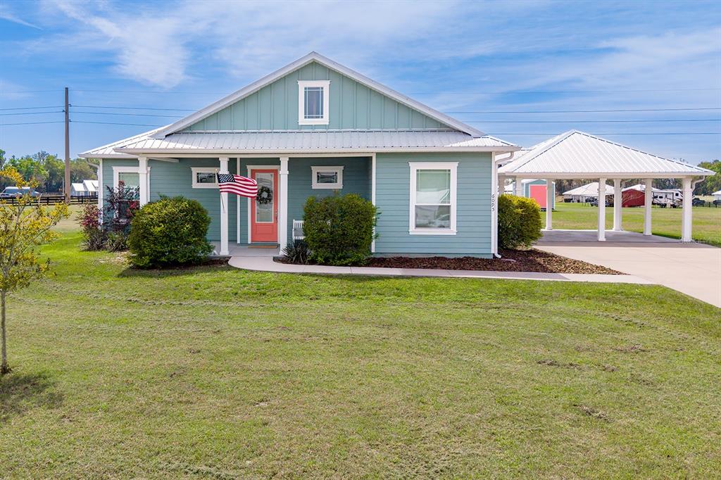 6095 Southwest 82nd Place Trenton, FL 32693 - Photo 5 of 44 a front view of a house with a yard