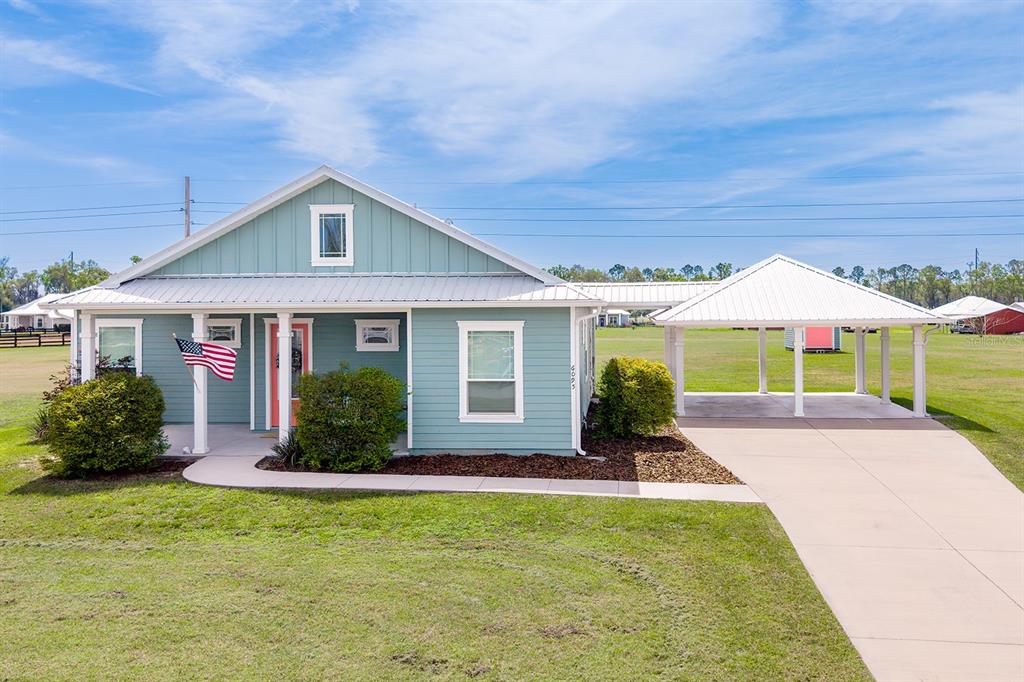 6095 Southwest 82nd Place Trenton, FL 32693 - Photo 6 of 44 a front view of a house with garden