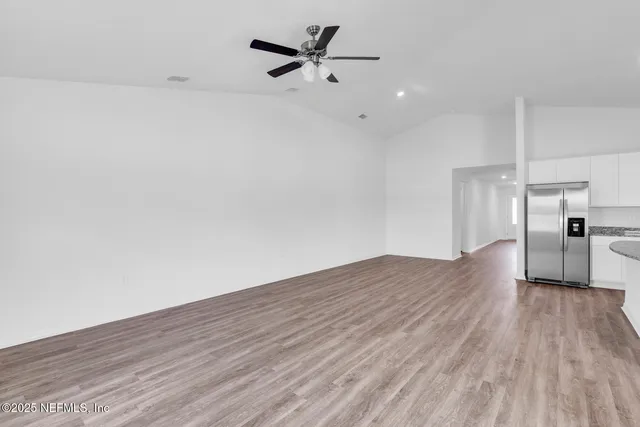 a view of a kitchen with a dishwasher and wooden floor
