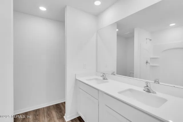 a bathroom with a sink double vanity and a mirror