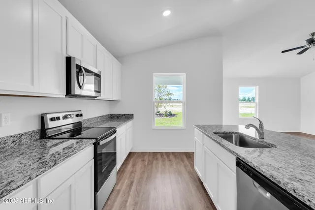 a kitchen that has a sink and a stove