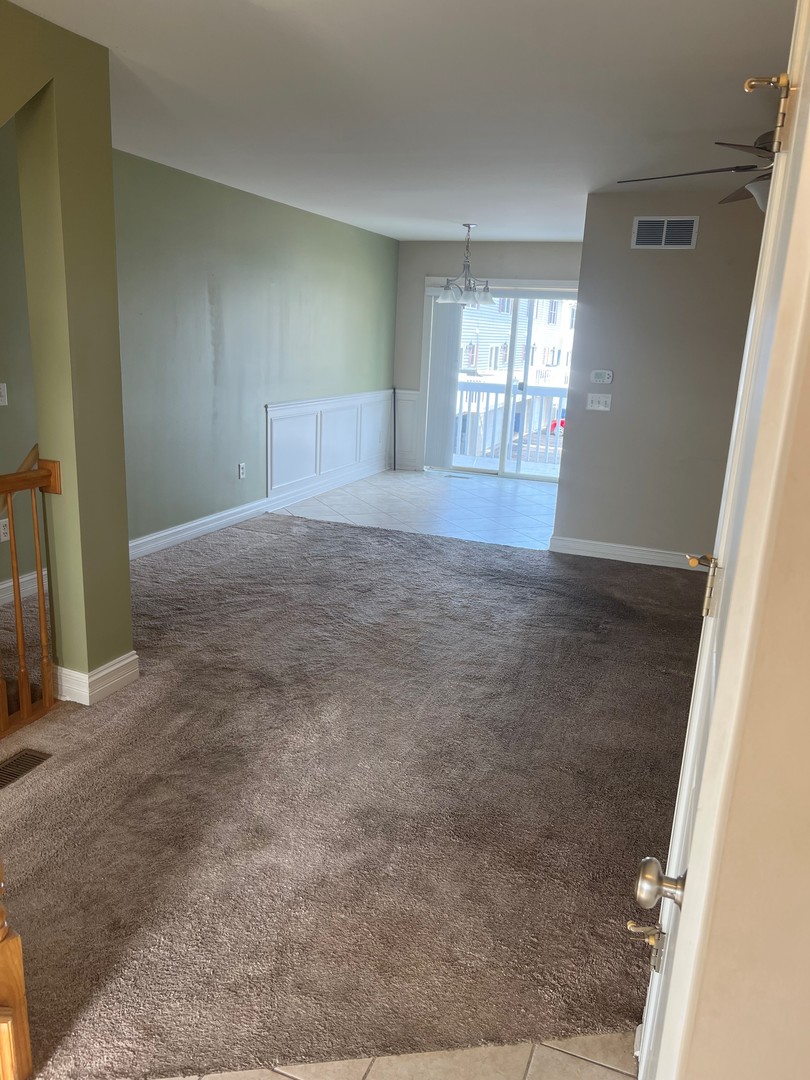 412 North Grainger Lane Cortland, IL 60112 - Photo 2 of 9 an empty room with windows