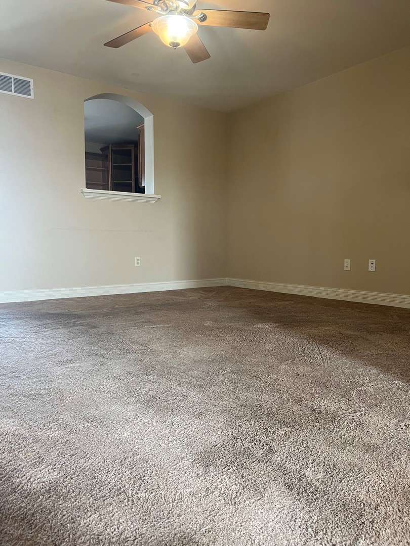 412 North Grainger Lane Cortland, IL 60112 - Photo 4 of 9 a view of an empty room with a chandelier fan