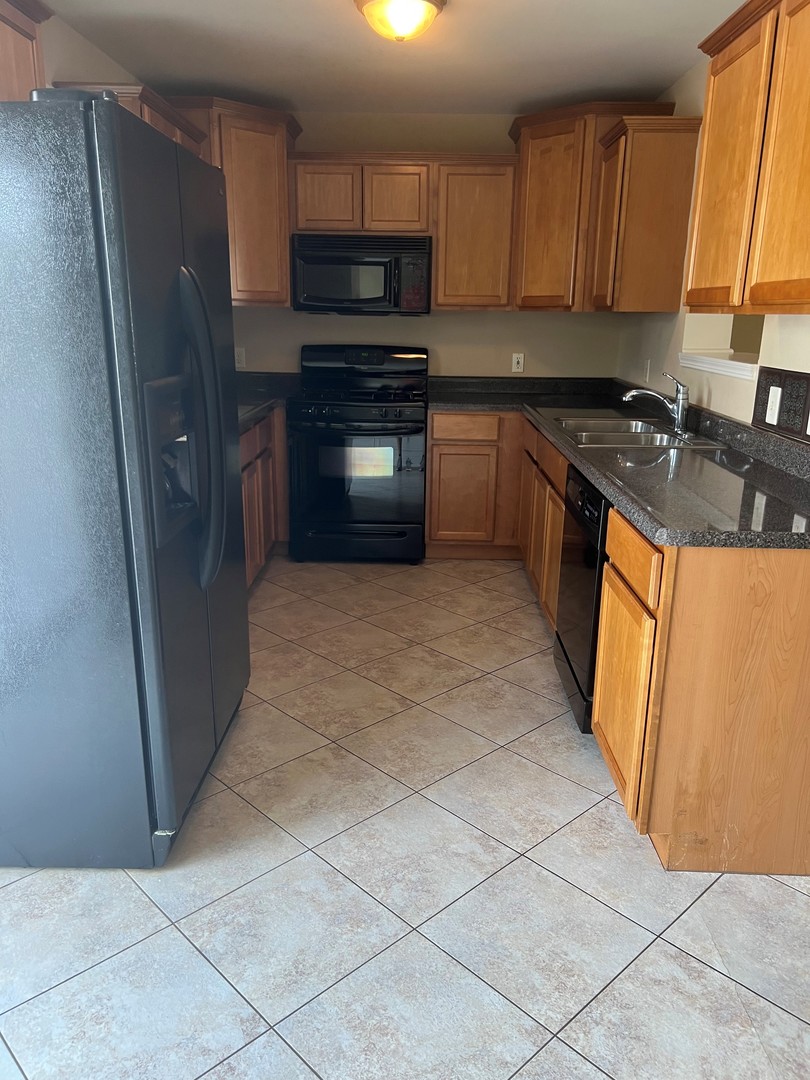 412 North Grainger Lane Cortland, IL 60112 - Photo 6 of 9 a kitchen with stainless steel appliances granite countertop a refrigerator stove a sink and dishwasher