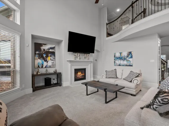 a living room with furniture fireplace and a flat screen tv