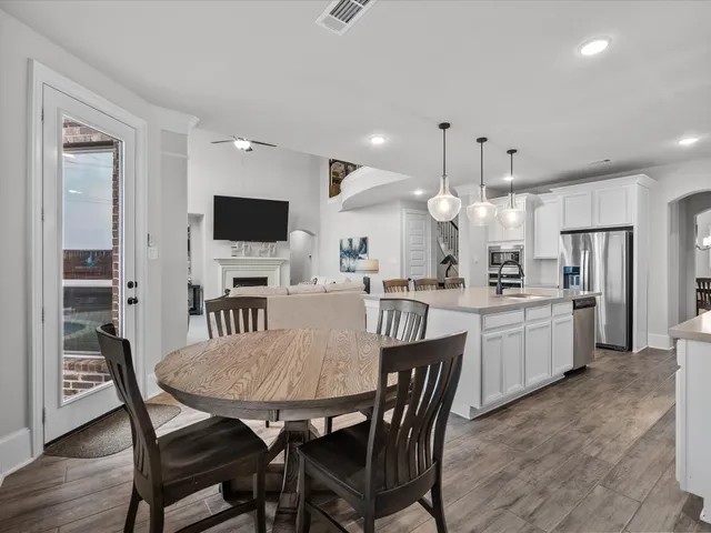 a large kitchen with a table and chairs