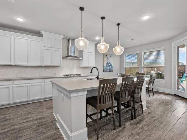 a view of dining table a sink a window and chairs