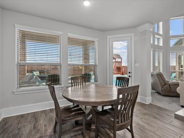 a view of a dining room with furniture and wooden floor