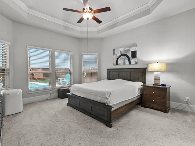 a spacious bedroom with a bed and window