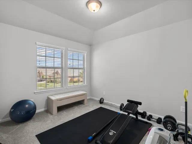 a room with a window and gym equipment